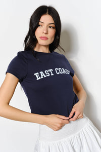 Woman wearing a navy blue t-shirt with 'EAST COAST' text on a plain background