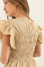Load image into Gallery viewer, Model wearing a lightweight cotton babydoll mini dress with smocked bodice, ruffled sleeves, and a flowy skirt—perfect for staying cool in summer. The dress features hidden side pockets and a relaxed fit, ideal for casual outings, beach vacations, or warm-weather brunches.
