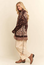 Load image into Gallery viewer, Chocolate brown tapestry-inspired jacquard knit cardigan with shawl collar, self-tie belt and multicolor fringe trim.
