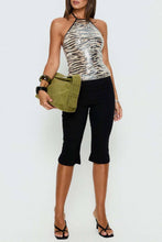 Load image into Gallery viewer, Women's sequin zebra print halter top styled with black trousers, oversized sunglasses, and statement silver jewelry.
