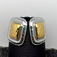 Load image into Gallery viewer, Pair of oversized two-tone statement earrings featuring sculptural rounded rectangular silver-tone frames and raised polished gold-tone centers.
