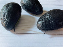 Load image into Gallery viewer, Realistic avocado-shaped coin purse with zipper, keychain ring, and bag charm attachment displayed on a wood background.
