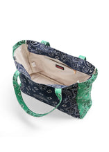 Load image into Gallery viewer, Oversized navy and green cotton canvas tote featuring a patchwork bandana paisley print, green side panels and matching shoulder straps on a white background.
