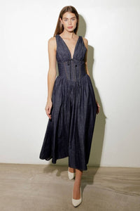 Turn heads in this elegant Solid Denim Corset Midi Dress! Featuring a deep V-neckline and sleeveless design, this dress is all about understated sophistication. The front tie detail and contouring waist accentuate your shape, while the flowing full skirt adds a touch of timeless charm. Perfect for dates, brunches, or evenings out, this versatile midi dress is a must-have for your wardrobe!