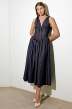 Load image into Gallery viewer, Turn heads in this elegant Solid Denim Corset Midi Dress! Featuring a deep V-neckline and sleeveless design, this dress is all about understated sophistication. The front tie detail and contouring waist accentuate your shape, while the flowing full skirt adds a touch of timeless charm. Perfect for dates, brunches, or evenings out, this versatile midi dress is a must-have for your wardrobe!
