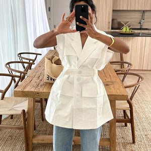 Make a bold statement with our Boxy White Belted Oversized Waistcoat. Featuring a stylish, boxy silhouette and a chic belt for a flattering fit, this versatile piece adds a modern edge to any outfit. Perfect for layering and elevating your look.