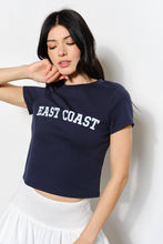 Load image into Gallery viewer, Woman wearing a navy blue crop top with &#39;EAST COAST&#39; text against a white background
