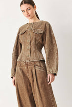 Load image into Gallery viewer, Women's vintage-washed brown denim jacket with a collarless round neckline, button front, chest pockets and sculpted fitted waist.
