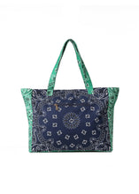 Load image into Gallery viewer, Oversized navy and green cotton canvas tote featuring a patchwork bandana paisley print, green side panels and matching shoulder straps on a white background.
