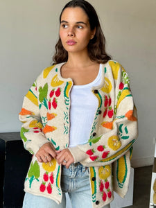 Brighten up any day with our Fruity Knit Cardigan Sweater! This cozy piece features an oversized fit for easy layering, complete with long sleeves and a ribbed hem for that perfect slouchy look. Crafted from a soft, medium-weight jacquard knit, it’s adorned with a playful multi-colored fruit pattern that’s sure to lift your spirits. With a button-up front and hip-length cut, this cardigan is designed for effortless style and comfort—One size truly fits most!