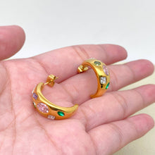 Load image into Gallery viewer, 18K gold-plated C-shaped hoop earrings inlaid with multicolored cubic zirconia stones in pink, purple, green and clear.
