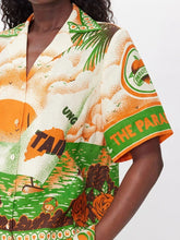 Load image into Gallery viewer, Elevate your summer style with the Peponi Tropical Shorts and Shirt Set. This vibrant ensemble features a stunning tropical island sunset print in shades of green, beige, white, brown, and orange. Perfect for warm weather, the breezy blouse and matching shorts capture the essence of an exotic getaway, making it a must-have for your wardrobe.
