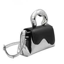 Load image into Gallery viewer, Meet our Silver and Black Top Handle Bag, one of the most unique and intricate handbags you will find. Made out of recycled vegan leather this metallic top handle bag makes a fashionable yet sustainable statement piece. Wear it comfortably as a crossbody bag using the adjustable strap for hands-free convenience. 
