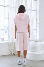 Load image into Gallery viewer, Light pink fleece Bermuda shorts with front pintuck detailing, elastic drawstring waistband, side pockets, relaxed fit, and soft stretch fabric.
