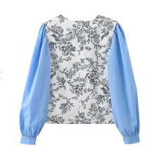 Load image into Gallery viewer, Introducing our Blue Puff Sleeved Floral Paneled Blouse – where chic meets elegance. Featuring a flattering V-neck and stylish puff sleeves, this blouse exudes sophistication with every detail. Perfect for any occasion, it’s a must-have addition to your wardrobe. Shop now before they’re gone!
