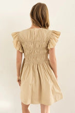 Load image into Gallery viewer, Model wearing a lightweight cotton babydoll mini dress with smocked bodice, ruffled sleeves, and a flowy skirt—perfect for staying cool in summer. The dress features hidden side pockets and a relaxed fit, ideal for casual outings, beach vacations, or warm-weather brunches.
