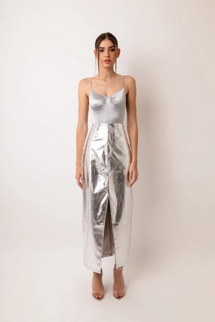 Our Silver Metallic Maxi Skirt is the skirt of the season! This high waisted maxi skirt in faux leather metallic fabric is set to become your wardrobe staple! Tailored to perfection this skirt fits like a dream and has a front slit and front fly fastening. Equally great with heels or flats this is definitely going to be the perfect summer wardrobe staple! Remix it with a chunky knit and boots in the Fall and Winter seasons.
