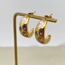 Load image into Gallery viewer, 18K gold-plated C-shaped hoop earrings inlaid with multicolored cubic zirconia stones in pink, purple, green and clear.
