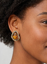 Load image into Gallery viewer, Gold statement earrings with amber resin stone and organic sculpted frame from Glam Expressway boutique.
