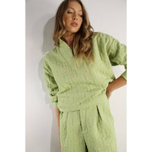 Load image into Gallery viewer, Apple green embossed half-zip pullover with relaxed fit and textured fabric styled as a chic lounge top.
