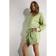 Load image into Gallery viewer, Apple green embossed half-zip pullover with relaxed fit and textured fabric styled as a chic lounge top.

