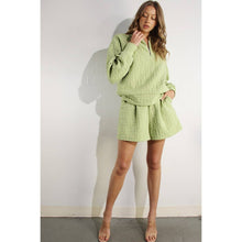 Load image into Gallery viewer, Apple green embossed half-zip pullover with relaxed fit and textured fabric styled as a chic lounge top.
