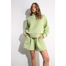 Load image into Gallery viewer, Apple green embossed lounge shorts with relaxed fit and textured fabric styled as part of a matching set.
