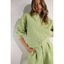Load image into Gallery viewer, Apple green embossed lounge shorts with relaxed fit and textured fabric styled as part of a matching set.
