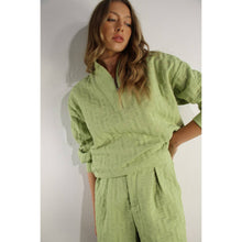 Load image into Gallery viewer, Apple green embossed lounge shorts with relaxed fit and textured fabric styled as part of a matching set.
