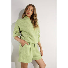 Load image into Gallery viewer, Apple green embossed lounge shorts with relaxed fit and textured fabric styled as part of a matching set.
