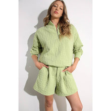 Load image into Gallery viewer, Apple green embossed lounge shorts with relaxed fit and textured fabric styled as part of a matching set.
