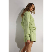 Load image into Gallery viewer, Apple green embossed lounge shorts with relaxed fit and textured fabric styled as part of a matching set.

