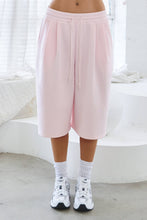 Load image into Gallery viewer, Light pink fleece Bermuda shorts with front pintuck detailing, elastic drawstring waistband, side pockets, relaxed fit, and soft stretch fabric.

