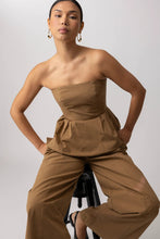 Load image into Gallery viewer, Woman wearing a beige strapless peblum top against a plain background
