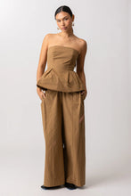 Load image into Gallery viewer, Woman wearing a brown strapless top and wide-leg pants on a white background
