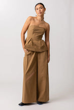 Load image into Gallery viewer, Woman wearing a brown strapless top and wide-leg pants on a white background
