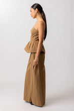 Load image into Gallery viewer, Woman wearing a brown strapless top and wide-leg pants on a white background
