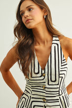 Load image into Gallery viewer, Black and cream abstract print tailored vest top with halter neckline and button front styled as a matching set.
