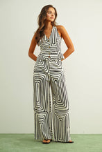 Load image into Gallery viewer, Black and cream abstract print tailored vest top with halter neckline and button front styled as a matching set.

