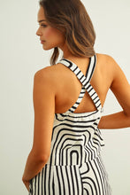 Load image into Gallery viewer, Black and cream abstract print tailored vest top with halter neckline and button front styled as a matching set.
