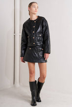 Load image into Gallery viewer, Woman wearing a black leather jacket and skirt with black boots on a white background
