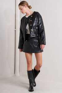 Woman wearing a black leather jacket, skirt, and boots from Glam Expressway 