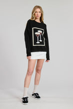 Load image into Gallery viewer, Person wearing a black sweater with a graphic design on a plain background

