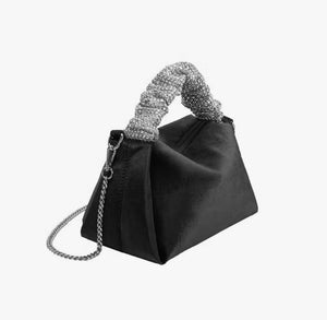 Upgrade your accessory game with the Crystal Top Handle Black Velvet Bag. This gorgeous evening bag is a statement piece designed to keep you stylish and organized throughout the holiday season. Our crystal handle velvet bag effortlessly combines fashion and function, making it your ideal companion for any occasion.