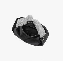 Load image into Gallery viewer, Upgrade your accessory game with the Crystal Top Handle Black Velvet Bag. This gorgeous evening bag is a statement piece designed to keep you stylish and organized throughout the holiday season. Our crystal handle velvet bag effortlessly combines fashion and function, making it your ideal companion for any occasion.
