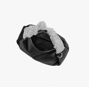 Upgrade your accessory game with the Crystal Top Handle Black Velvet Bag. This gorgeous evening bag is a statement piece designed to keep you stylish and organized throughout the holiday season. Our crystal handle velvet bag effortlessly combines fashion and function, making it your ideal companion for any occasion.