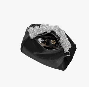 Upgrade your accessory game with the Crystal Top Handle Black Velvet Bag. This gorgeous evening bag is a statement piece designed to keep you stylish and organized throughout the holiday season. Our crystal handle velvet bag effortlessly combines fashion and function, making it your ideal companion for any occasion.