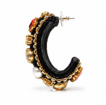 Load image into Gallery viewer, Side profile of black velvet hoop earrings featuring dimensional crystal embellishments and pearl accents.
