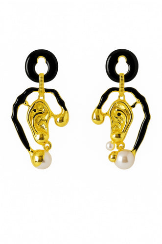 Abstract gold and black enamel statement earrings with sculptural shapes and pearl drop details, photographed on a white background.