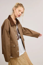 Load image into Gallery viewer, Utility-style lined jacket with a contrasting corduroy point collar, front snap closure, and front snap-flap patch pockets, designed with a boxy and oversized silhouette.
